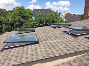 Photo of a roof with open Wasco E-Class Solar powered motorized venting Skylights 